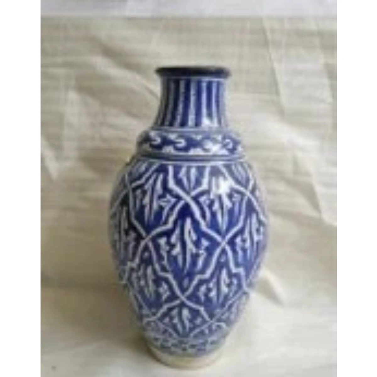 blue and white vase with intricate  islamic patterns