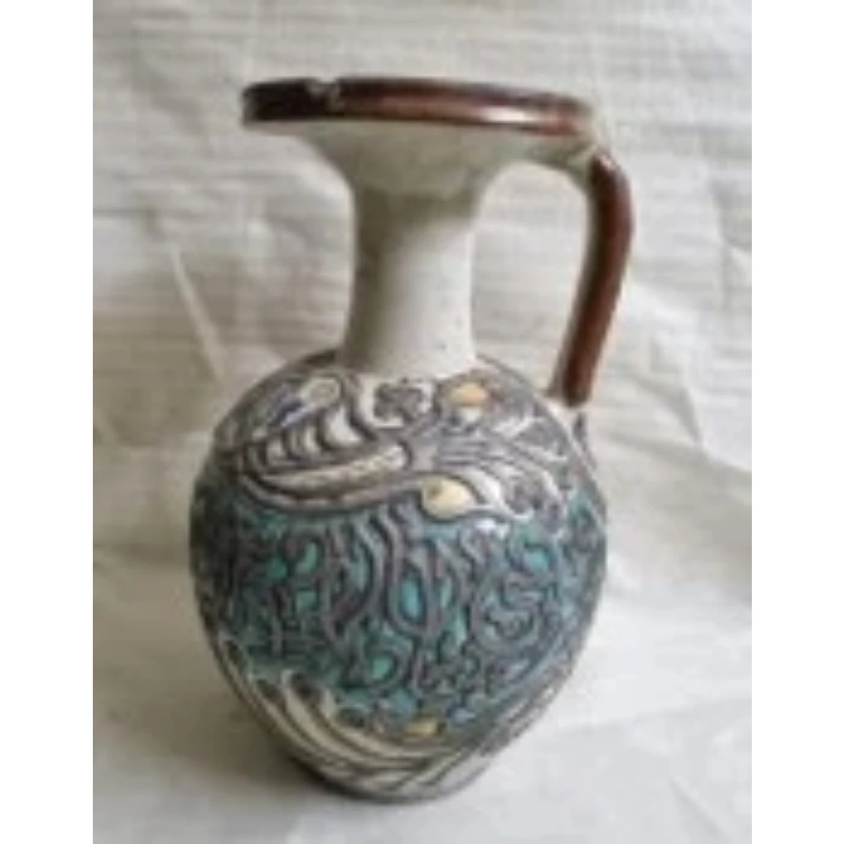 Metal mounted polychrome ceramic Jug