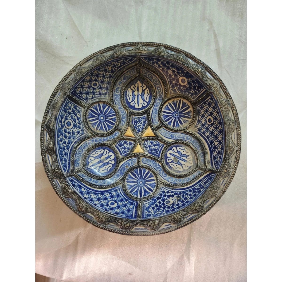 Large white metal-mounted blue bowl