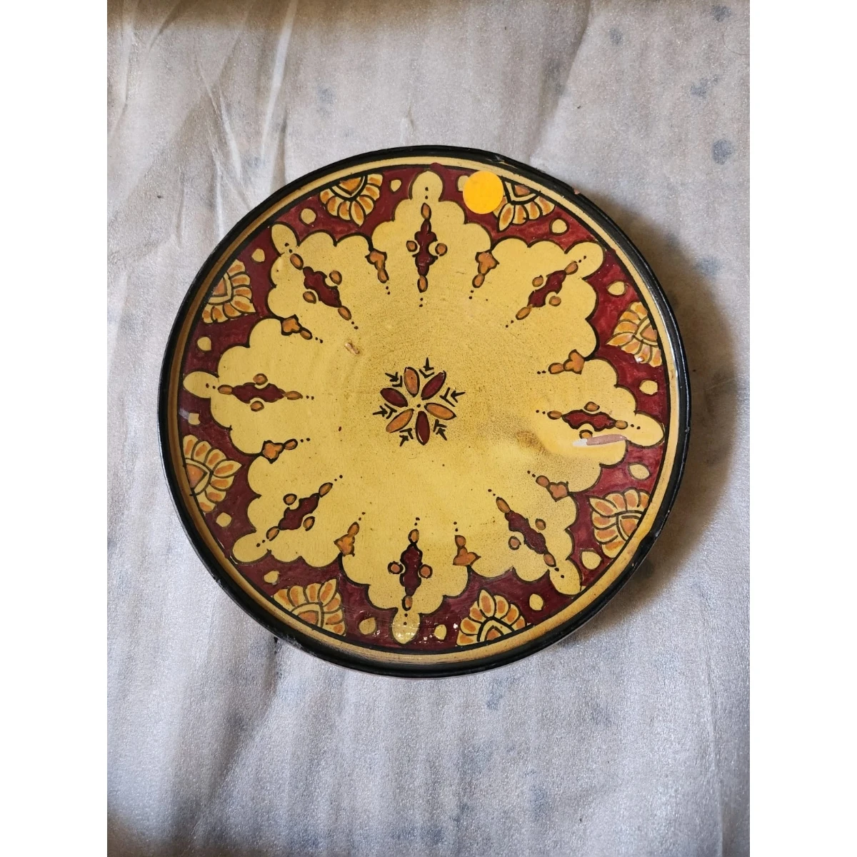 red and yellow ceramic dish