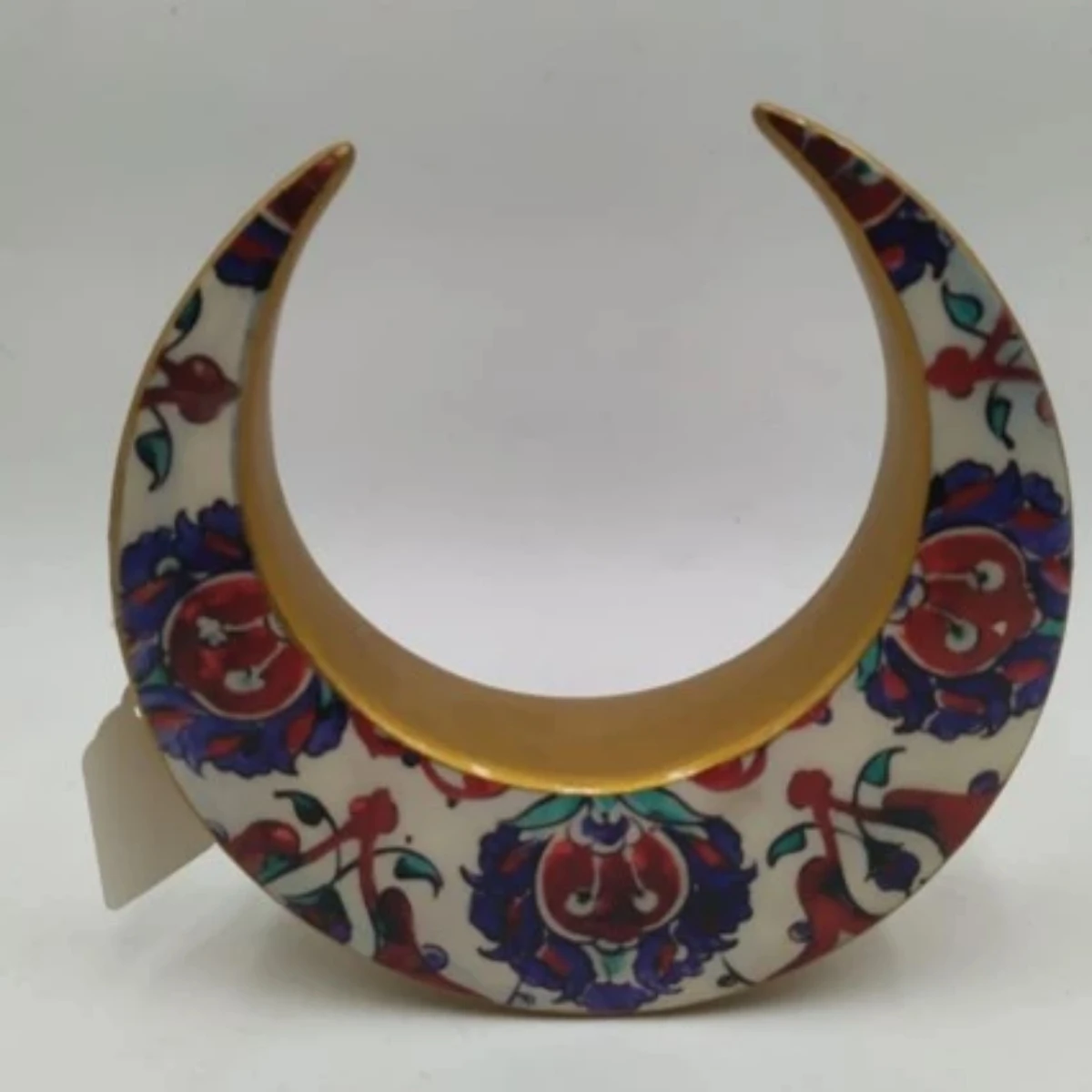 Ceramic crescent with a floral design