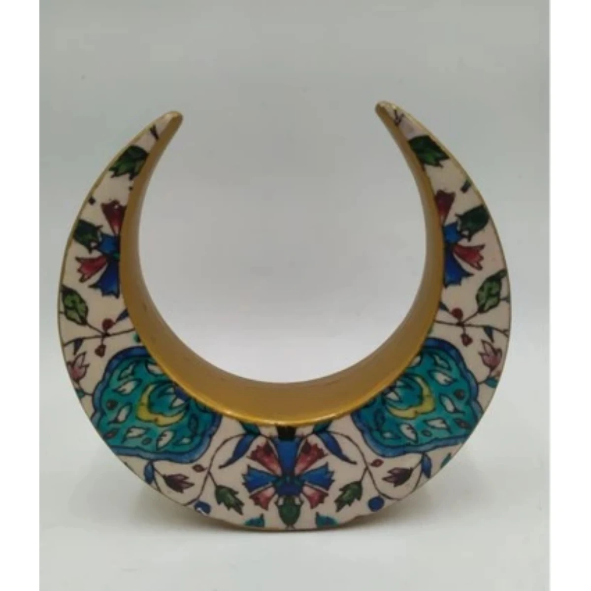Ceramic crescent with a floral design